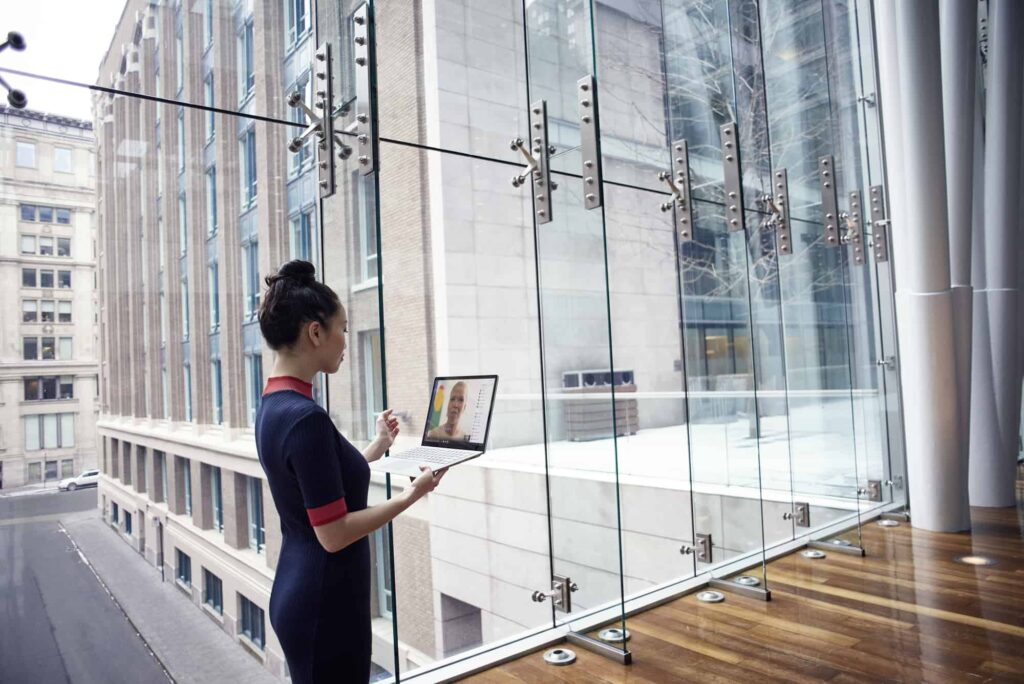 Woman with laptop in open office space
